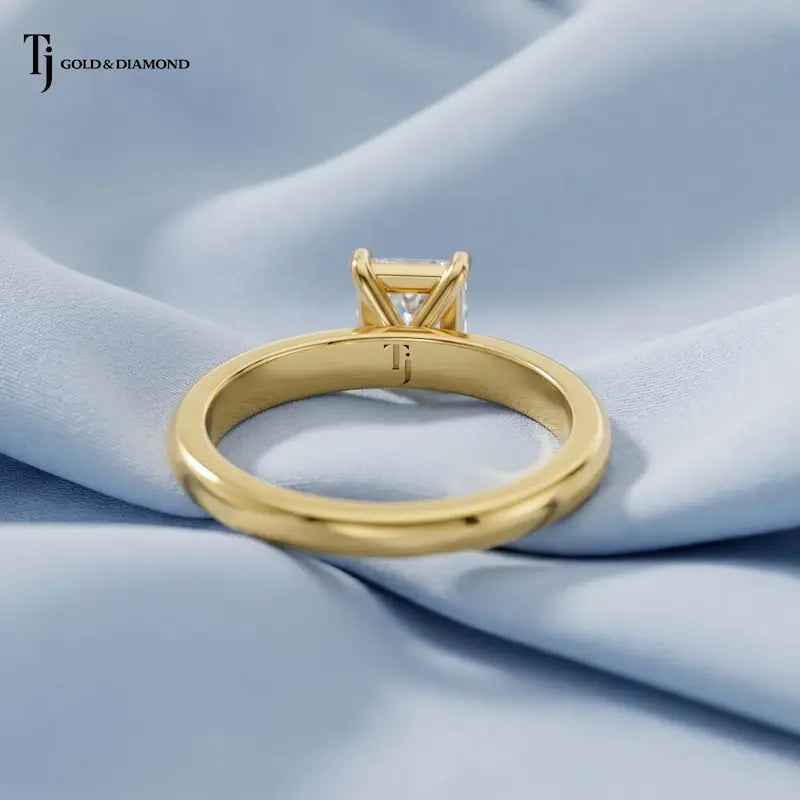1.5 carat radiant cut lab-grown diamond solitaire engagement ring in 18kt yellow gold, back view on pink silk