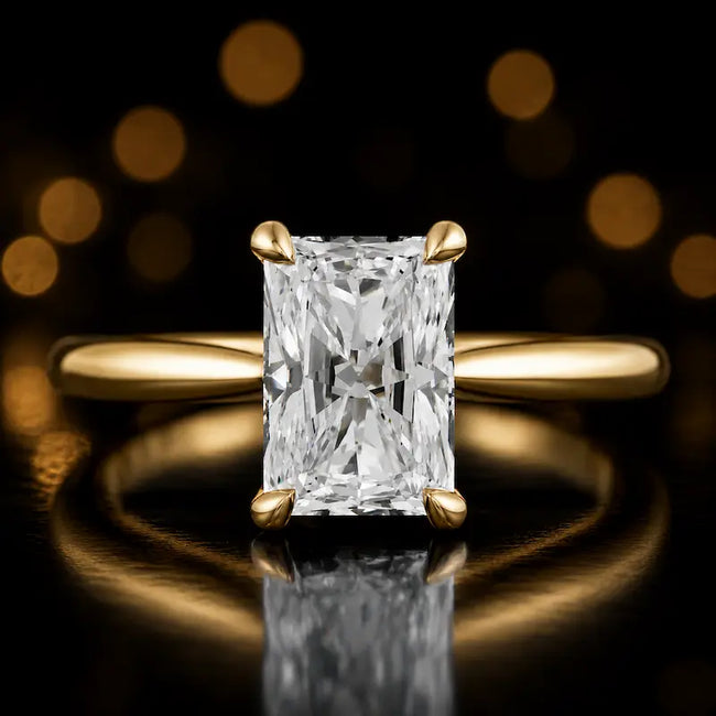 Front view of a 1.5 carat Radiant cut diamond solitaire engagement ring in an 18kt yellow gold 4 claw setting by TJ Diamond