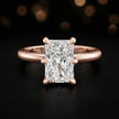 Front view of a 1.5 carat radiant cut diamond solitaire engagement ring in an 18kt rose gold 6 claw setting by TJ Diamond
