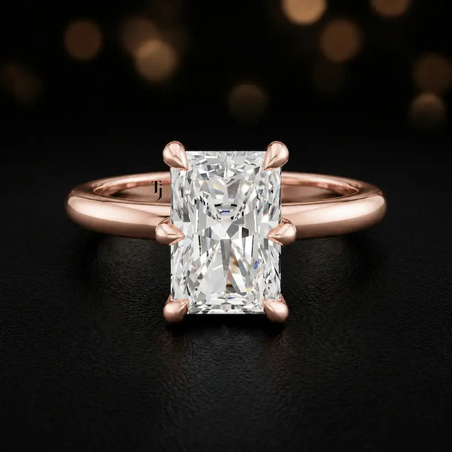 Front view of a 1.5 carat radiant cut diamond solitaire engagement ring in an 18kt rose gold 6 claw setting by TJ Diamond