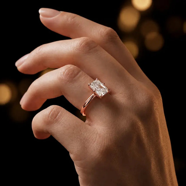1.5 carat radiant cut diamond solitaire engagement ring in an 18kt rose gold 6 claw setting worn on a hand, by TJ Diamond