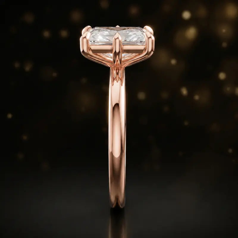 Side profile of a 1.5 carat radiant cut diamond solitaire engagement ring showing the cathedral setting and 18kt rose gold band by TJ Diamond