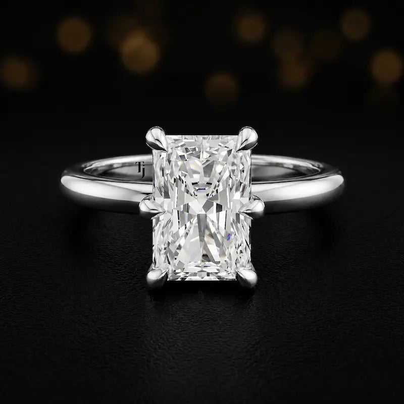 Front view of a 1.5 carat radiant cut diamond solitaire engagement ring in an 18kt white gold 6 claw setting by TJ Diamond