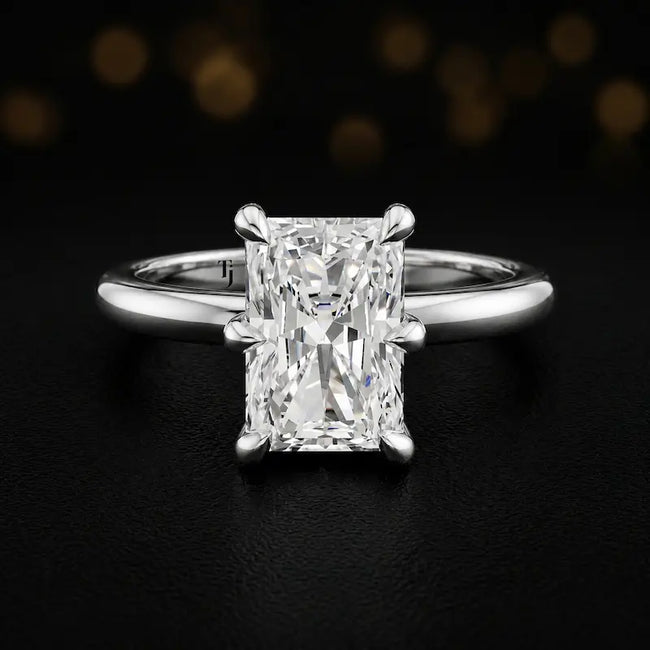 Front view of a 1.5 carat radiant cut diamond solitaire engagement ring in an 18kt white gold 6 claw setting by TJ Diamond