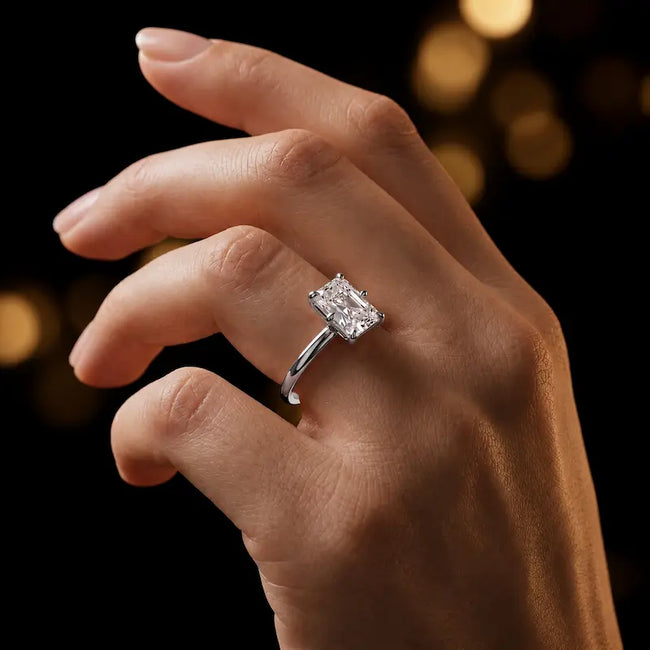 1.5 carat radiant cut diamond solitaire engagement ring in an 18kt white gold 6 claw setting worn on a hand, by TJ Diamond