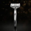 Side profile of a 1.5 carat radiant cut diamond solitaire engagement ring showing the cathedral setting and 18kt white gold band by TJ Diamond
