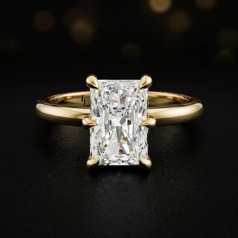 Front view of a 1.5 carat radiant cut diamond solitaire engagement ring in an 18kt yellow gold 6 claw setting by TJ Diamond