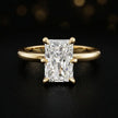 Front view of a 1.5 carat radiant cut diamond solitaire engagement ring in an 18kt yellow gold 6 claw setting by TJ Diamond