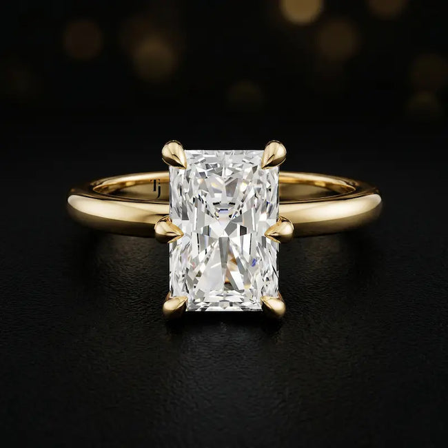 Front view of a 1.5 carat radiant cut diamond solitaire engagement ring in an 18kt yellow gold 6 claw setting by TJ Diamond