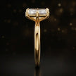Side profile of a 1.5 carat radiant cut diamond solitaire engagement ring showing the cathedral setting and 18kt yellow gold band by TJ Diamond