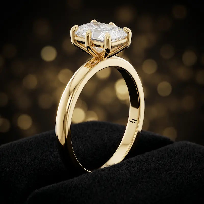 Front-on view of a 1.5 carat radiant cut diamond solitaire engagement ring showing the full 18kt yellow gold band and 6 claw cathedral setting by TJ Diamond