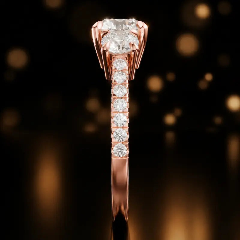 Side profile of a round cut three-stone lab-grown diamond engagement ring in 18kt rose gold showing the diamond band