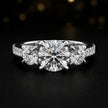 Front view of a round cut three-stone lab-grown diamond engagement ring in 18kt white gold with diamond shoulders
