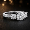 Side view of a round cut three-stone lab-grown diamond engagement ring in 18kt white gold with diamond shoulders