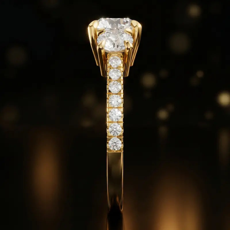 Side profile of a round cut three-stone lab-grown diamond engagement ring in 18kt yellow gold showing the diamond band