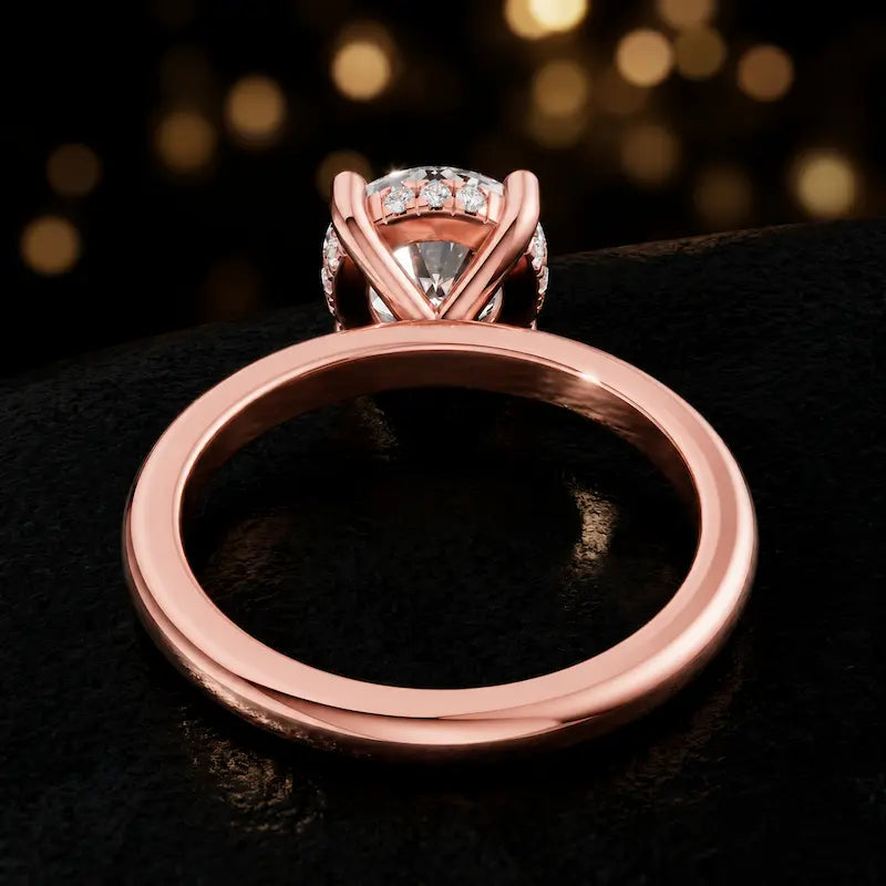 Back view of 4-claw round cut engagement ring with hidden halo in 18kt rose gold