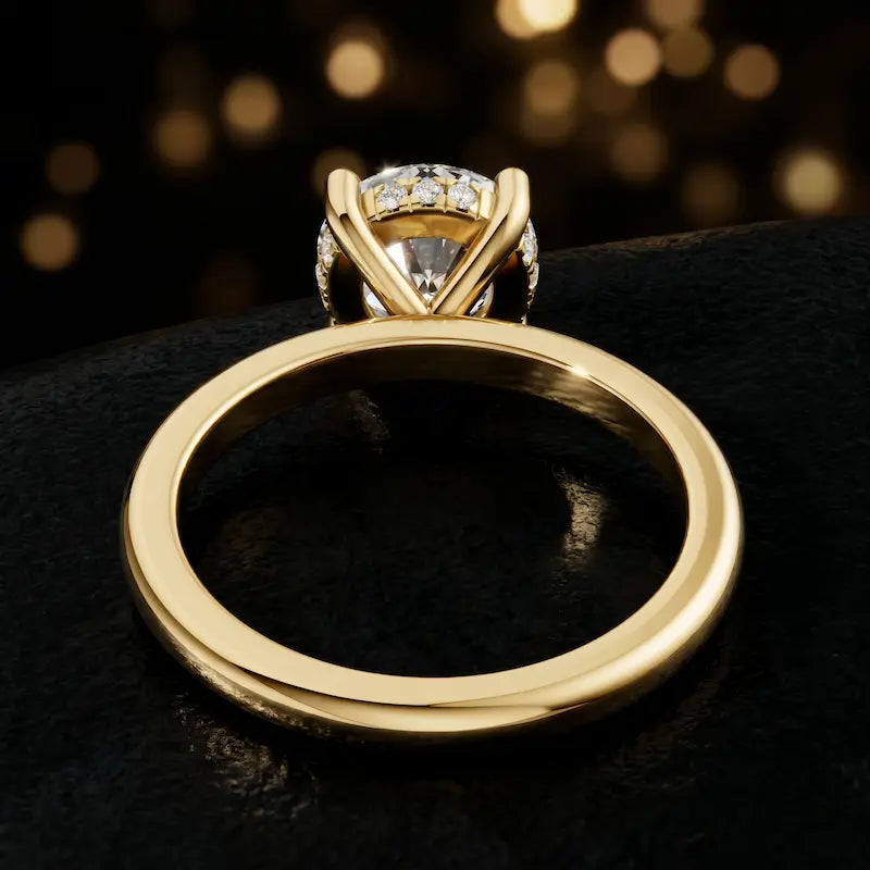 Back view of 4-claw round cut engagement ring with hidden halo in 18kt yellow gold