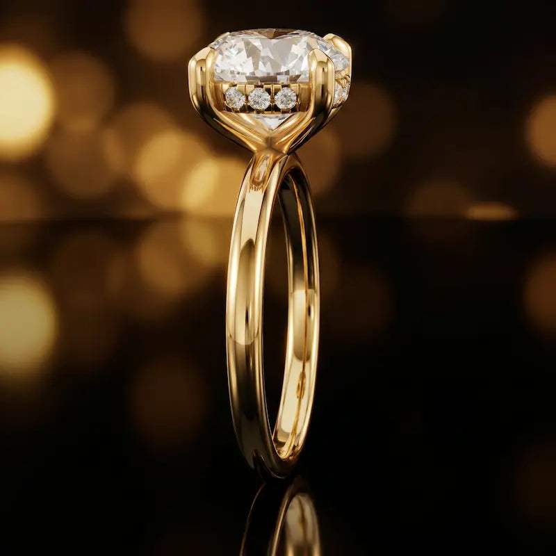 Side profile of 4-claw round cut engagement ring with hidden halo in 18kt yellow gold