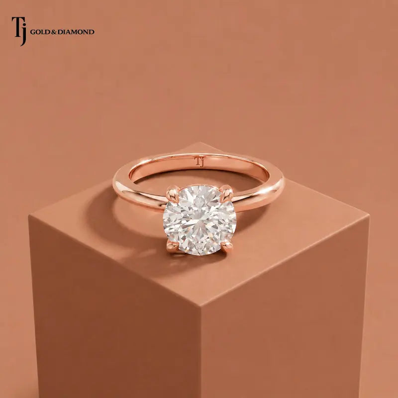 Front view of a 1.5 carat round cut lab-grown diamond solitaire engagement ring in 18kt rose gold with a 4-claw setting
