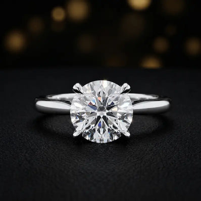 Front view of a 1.5 carat round brilliant cut diamond solitaire engagement ring in an 18kt white gold 4 claw setting by TJ Diamond