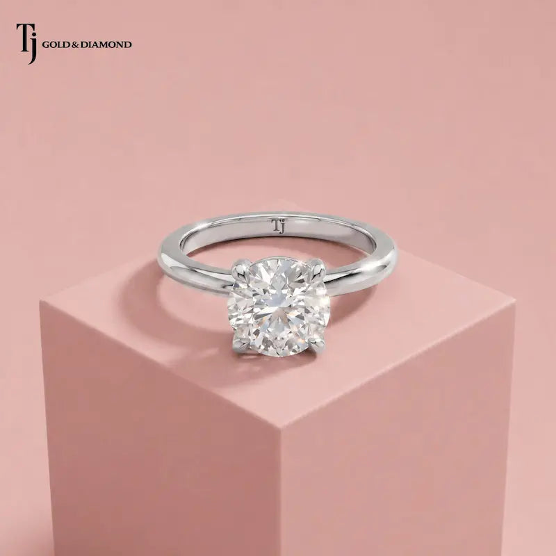 Front view of a 1.5 carat round cut lab-grown diamond solitaire engagement ring in 18kt white gold with a 4-claw setting