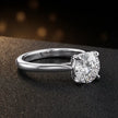 Angled side view of a 1.5 carat round brilliant cut diamond solitaire engagement ring in an 18kt white gold 4 claw setting by TJ Diamond