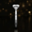 Side profile of a 1.5 carat round brilliant cut diamond solitaire engagement ring showing the cathedral setting and 18kt white gold band by TJ Diamond