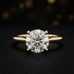 Front view of a 1.5 carat round brilliant cut diamond solitaire engagement ring in an 18kt yellow gold 4 claw setting by TJ Diamond