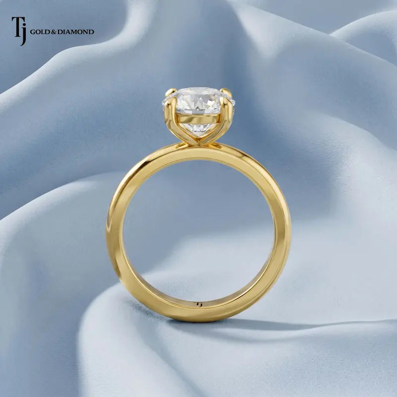 Front-on standing view of a 1.5 carat round cut lab-grown diamond solitaire engagement ring in 18kt yellow gold showing the band profile
