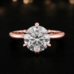 Front view of a 1.5 carat round brilliant cut diamond solitaire engagement ring in an 18kt rose gold 6 claw setting by TJ Diamond