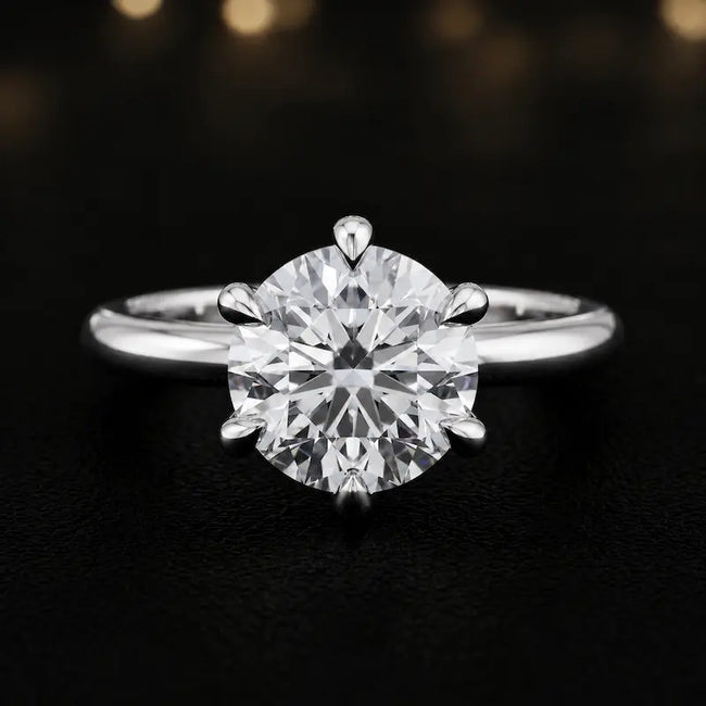 Front view of a 1.5 carat round brilliant cut diamond solitaire engagement ring in an 18kt white gold 6 claw setting by TJ Diamond