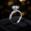 Angled side view of a 1.5 carat round brilliant cut diamond solitaire engagement ring in an 18kt white gold 6 claw setting by TJ Diamond