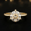 Front view of a 1.5 carat round brilliant cut diamond solitaire engagement ring in an 18kt yellow gold 6 claw setting by TJ Diamond