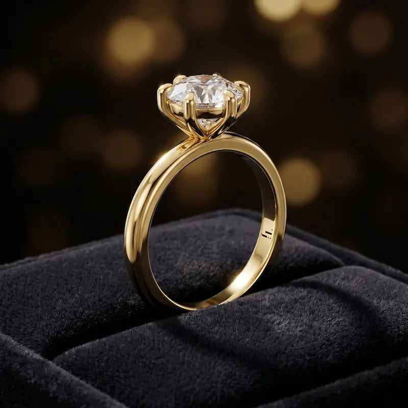 ront-on view of a 1.5 carat round brilliant cut diamond solitaire engagement ring presented in a TJ Diamond ring box, showing the full 18kt yellow gold band and 6 claw cathedral setting