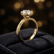 ront-on view of a 1.5 carat round brilliant cut diamond solitaire engagement ring presented in a TJ Diamond ring box, showing the full 18kt yellow gold band and 6 claw cathedral setting