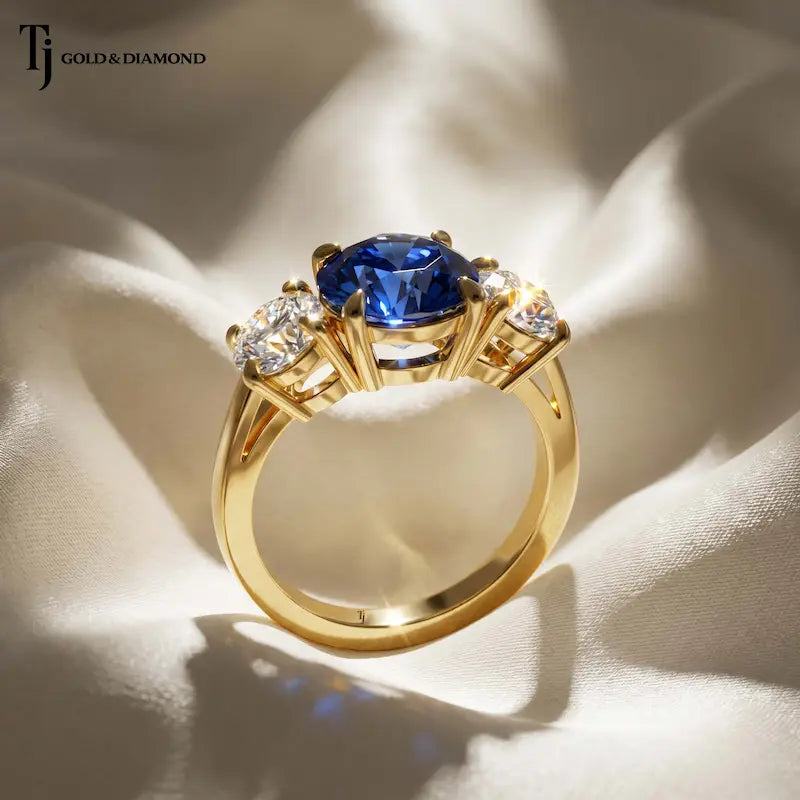 Side view of a Round Cut Lab-Created Blue Sapphire & Lab-Grown Diamond Trilogy Ring showing the elevated three stone basket setting in 18kt yellow gold.