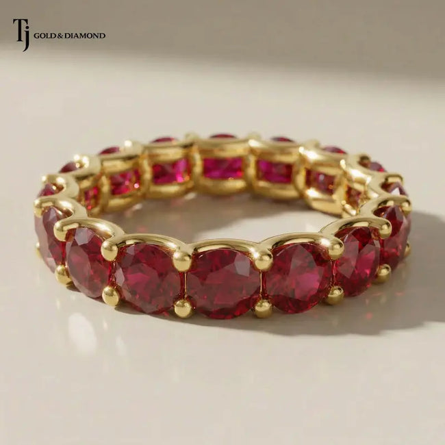 Created ruby full eternity ring in 18kt yellow gold featuring round brilliant lab-created rubies in a shared prong setting.