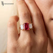 Close Up view of Emerald cut lab-created ruby trilogy engagement ring in 18kt yellow gold with emerald cut lab-grown diamond side stones worn on hand