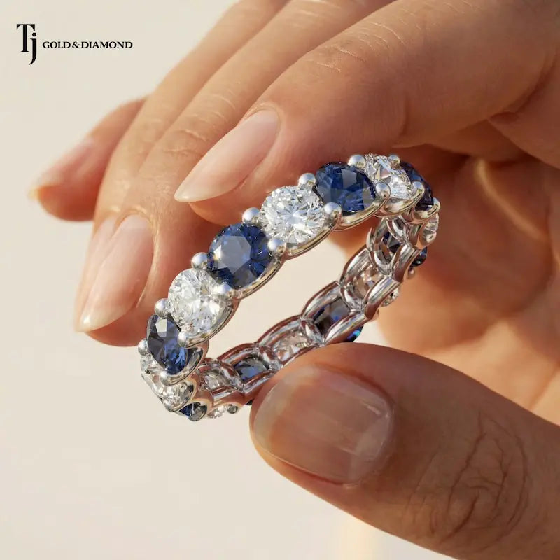 Created Sapphire & Lab-Grown Diamond Full Eternity Ring in 18kt White Gold held in hand, handcrafted by TJ Gold & Diamond.