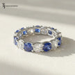 Front View of Created Sapphire & Lab-Grown Diamond Full Eternity Ring in 18kt White Gold featuring alternating round blue sapphires and brilliant lab-grown diamonds.