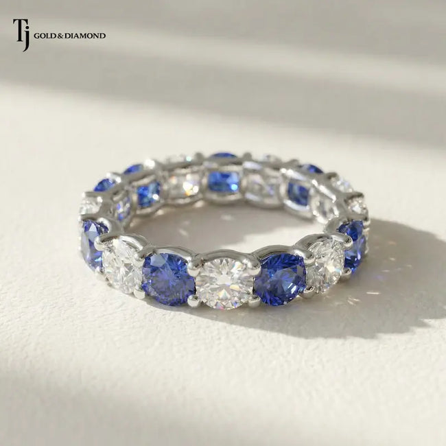 Front View of Created Sapphire & Lab-Grown Diamond Full Eternity Ring in 18kt White Gold featuring alternating round blue sapphires and brilliant lab-grown diamonds.