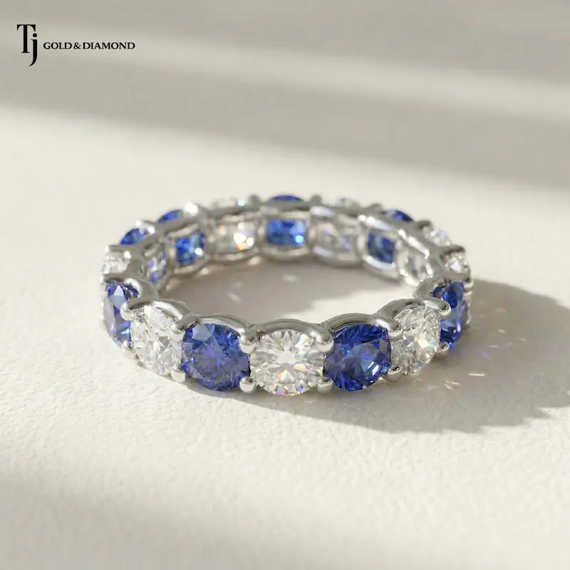 Front View of Created Sapphire & Lab-Grown Diamond Full Eternity Ring in 18kt White Gold featuring alternating round blue sapphires and brilliant lab-grown diamonds.