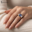 Created emerald cut sapphire and diamond trilogy ring worn on hand in 18kt yellow gold showcasing the elegant proportions and everyday wear.