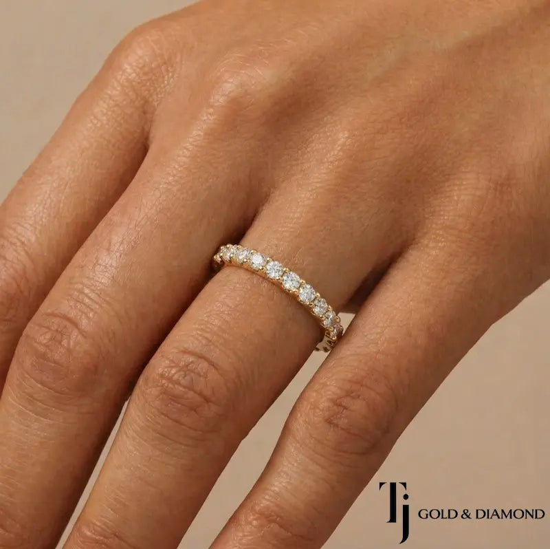 Scallop setting full eternity diamond wedding band in 18kt yellow gold worn on hand with round brilliant lab-grown diamonds.