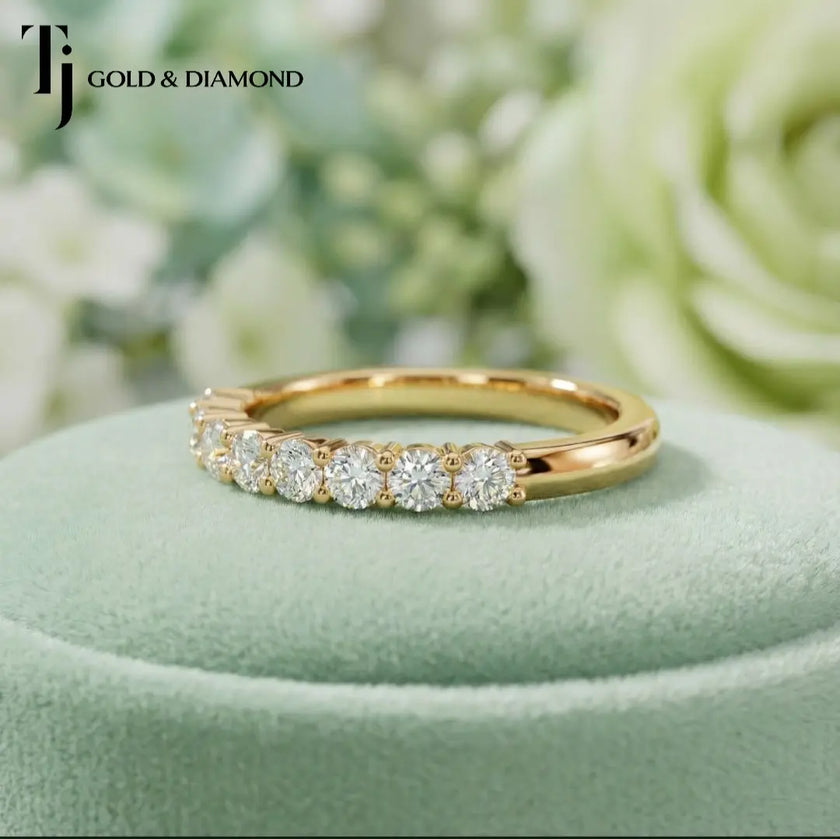 Side view of Shared Prong Half Eternity diamond wedding band in 18kt yellow gold, showing round brilliant diamonds along the band