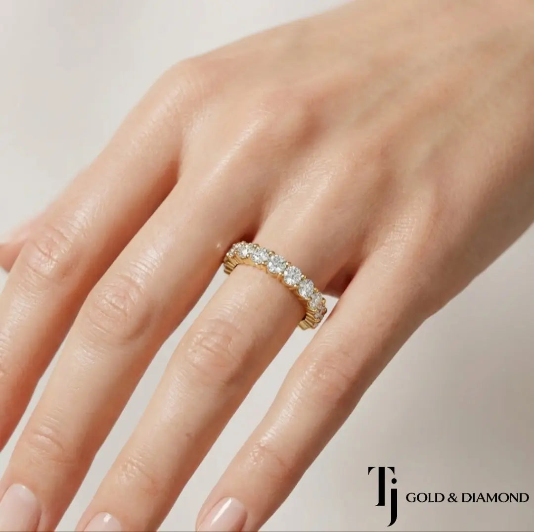Shared Prong Half Eternity diamond wedding band worn on hand, 18kt yellow gold with round brilliant lab-grown diamonds
