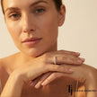 Model wearing Shared Prong Half Eternity diamond wedding band in 18kt yellow gold, close-up lifestyle shot