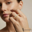 Model wearing a shared prong setting full eternity diamond wedding band in 18kt yellow gold with round brilliant lab-grown diamonds.