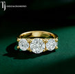 Three stone round diamond engagement ring in yellow gold featuring 3 diamonds in a classic trilogy design