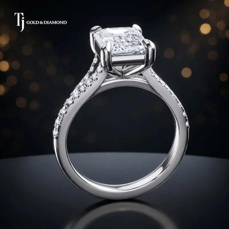 Side view of an emerald cut split shank lab-grown diamond engagement ring featuring a four-claw cathedral setting in 18kt white gold.